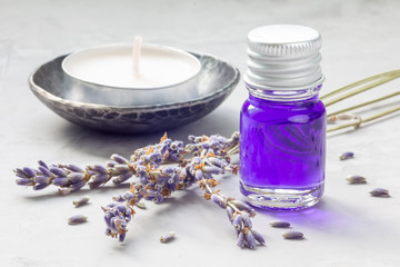 Obraz na płótnie Canvas Lavender oil in a glass bottle. Horizontal close-up