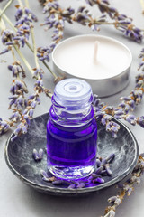 Obraz na płótnie Canvas Lavender oil in a glass bottle. Vertical close-up
