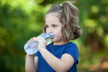 Cute little girl with water bottle
