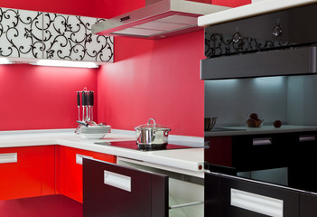 Luxurious new red kitchen with modern appliances