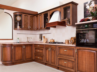 Luxurious new brown kitchen with modern appliances