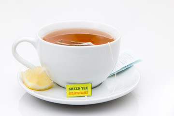 Decaf Green Tea in a white cup with lemon on a white background