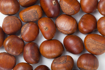 Group of grilled chestnuts. On white background. Autumn background.