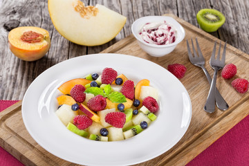 delicious fruit  and berry summer salad decorated with mint leav