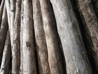 A pale of grey wooden logs