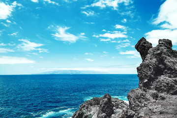 beautiful view from the cliff of mountain to the ocean with blue sky and clouds