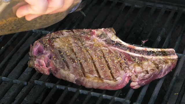 Seasoning Bone-In Rib-Eye Steak on Grill, 4K