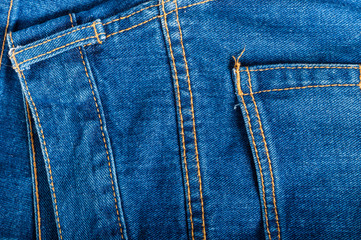 Closeup photo of denim jeans showing texture and stitching.