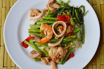 stir fried morning glory with seafood and meat on rice