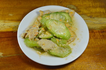 stir fried ridge gourd with egg and pork on dish