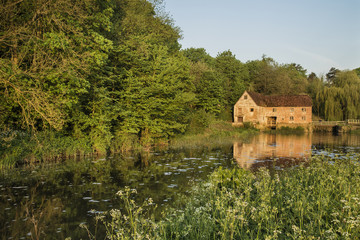 Fototapeta na wymiar Early morning landscape across River to old water Mill