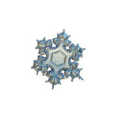Snowflake isolated on white background. This is macro photo of real snow crystal with short arms with complex pattern and almost empty center, captured in yellow light at glass surface.