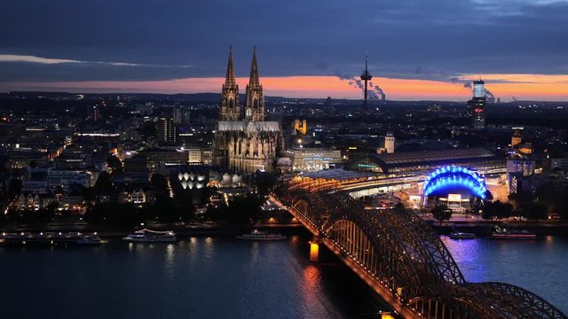 Night panning shot of Cologne Cathedral and Hohenzollern Bridge. Cologne, Germany.