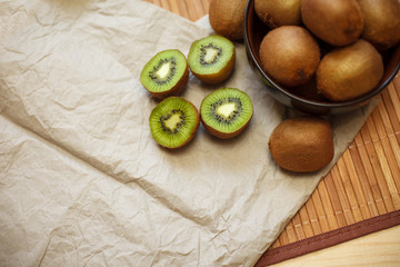 Still life. Tropical fruit. Juicy kiwi on the wooden table