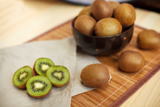 Still life. Tropical fruit. Juicy kiwi on the wooden table