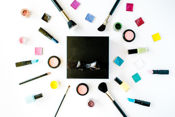 flat lay female cosmetics collage box with lipstick, brush on white background. top view set