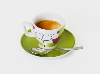 Colorful coffee cup with spoon on white background