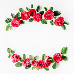 flat lay frame with red roses, branches, leaves and petals isolated on white background. top view