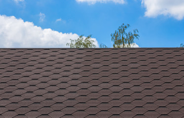 Part of texture with shingles roof and blue sky