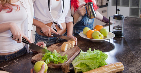 hand of a woman housewife preparing dinner, lettuce on cutting board in kitchen