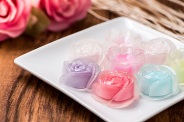 Rose jelly in plate on wood table