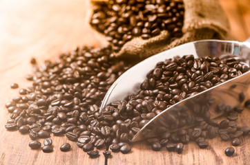 coffee bean in metal scoop on wood table, vintage style