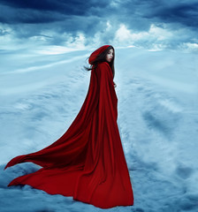  fantasy woman Little Red Riding Hood is going away on a snowy road and clouds. Dramatic and fantastic shooting, fashionable toning, creative colors. Girl fairy tale princess © kharchenkoirina