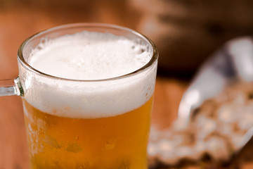 beer in mug glass with bean on wood table