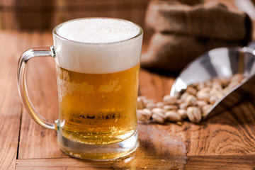 beer in mug glass with bean on wood table