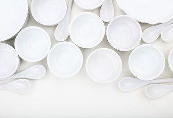 White empty bowls and spoons composition