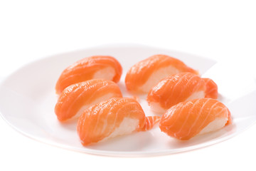 Fresh japanese salmon sushi in plate on white background