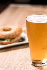 beer in glass and burger on wood table