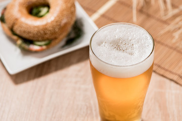 beer in glass and burger on wood table