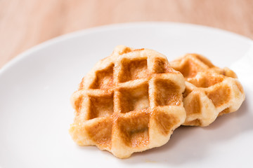 Waffles in bowl on wood table