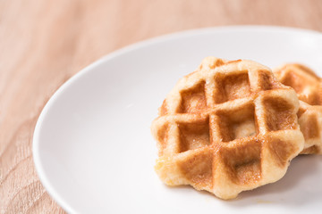 Waffles in bowl on wood table