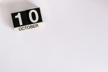 October 10th. Day 10 of month, wooden color calendar on white background. Autumn concept. Empty space for text