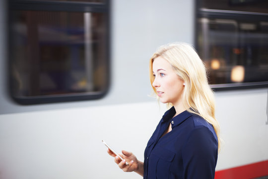 Woman at platform using her phone