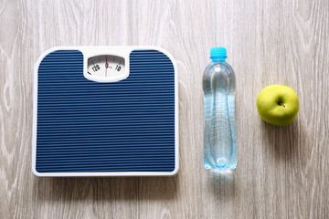 Floor scales on wooden background