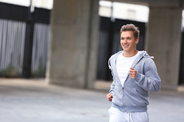 Young man running on the street