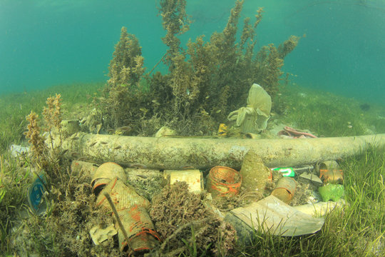 Plastic bottles and bags pollution underwater on sea bed