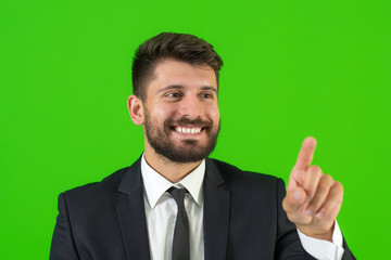 The businessman show the finger on the green background