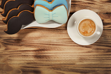 Happy Father's Day concept. Tasty cookies and cup of coffee on wooden background