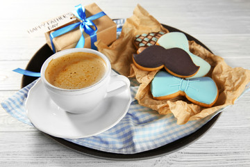 Happy Father's Day concept. Tasty cookies and cup of coffee on wooden background