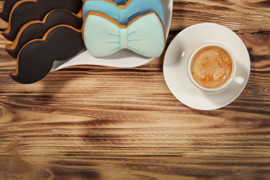 Happy Father's Day concept. Tasty cookies and cup of coffee on wooden background
