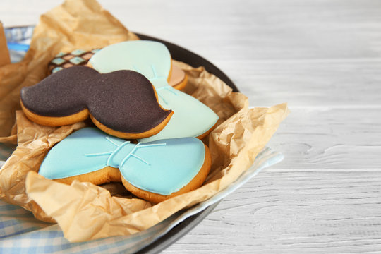 Happy Father's Day concept. Plate with tasty cookies on wooden background