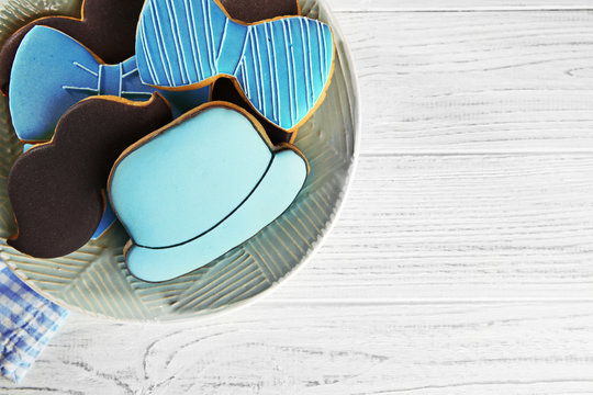 Happy Father's Day concept. Plate with tasty cookies on wooden background