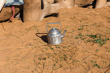 old teapot on the sand in the Sahara Desert