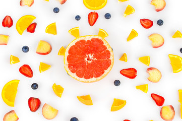 Various fresh summer fruits and berries isolated on a white background. Top view.