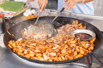 Chef prepares fried potatoes. Street food. Malaysia. Penang