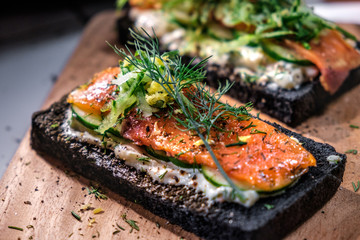 Charcoal Bread Smoked Salmon Sandwiches on wood board